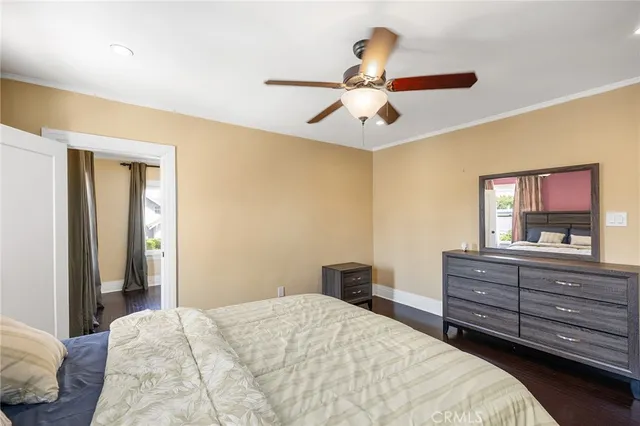 a bedroom with a bed and a painting on the wall