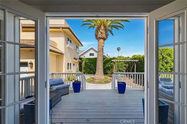 an aerial view of a residential apartment building with a yard and parking spaces