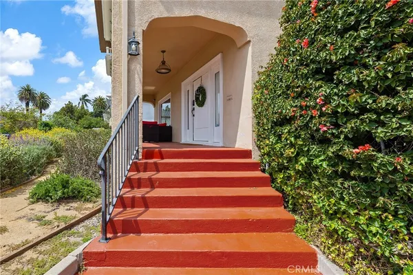 a view of an empty room with wooden floor and windows