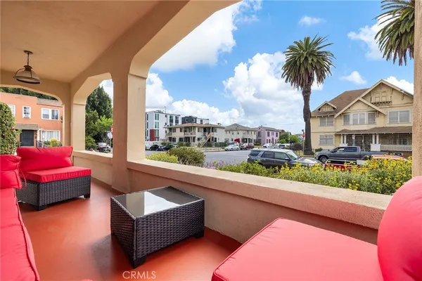 a view of an empty room with wooden floor and windows