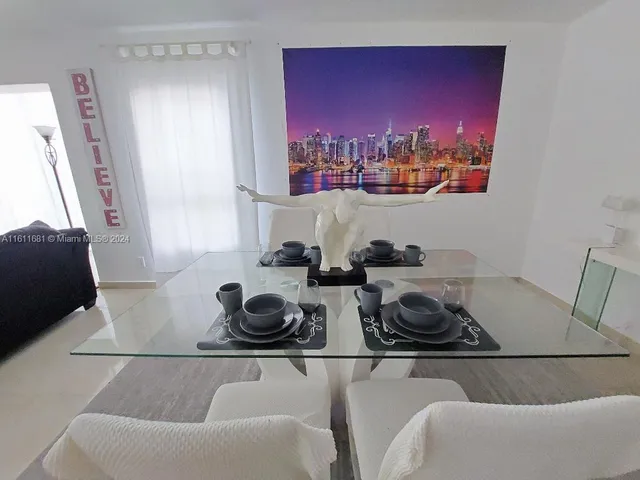 a living room with furniture a dining table and a bookshelf