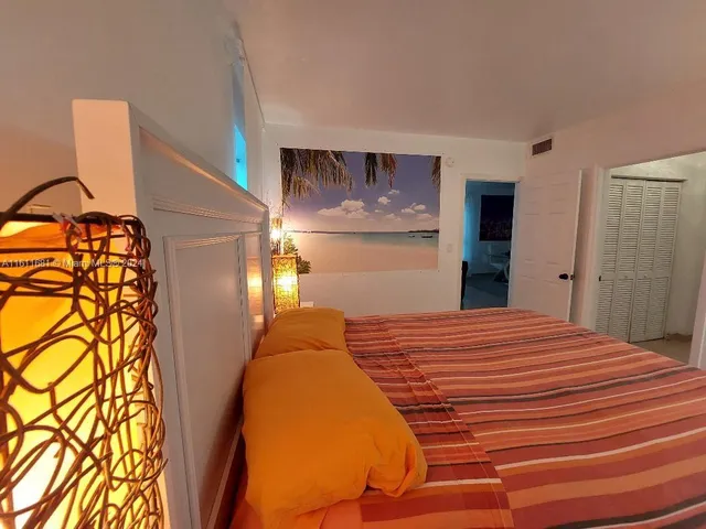 a bedroom with a bed and lamps