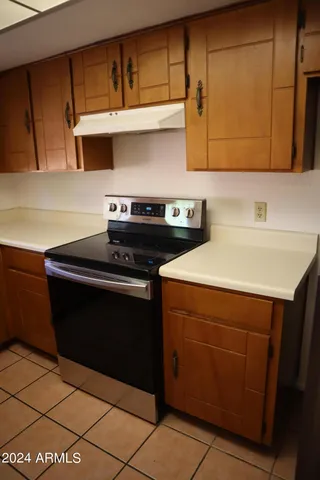 a kitchen with stainless steel appliances a stove a sink and cabinets