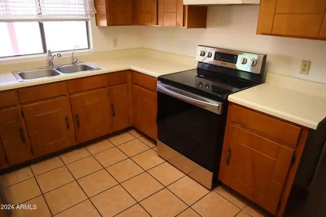 a kitchen with a sink cabinets and wooden floor