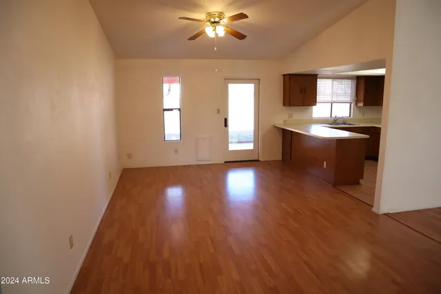 a view of a kitchen with wooden floor and a kitchen