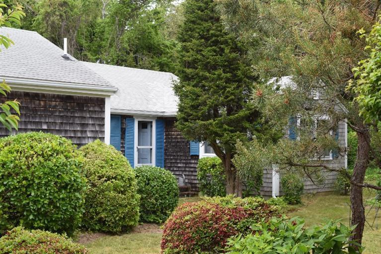 62 Cedar Land Road Orleans, MA 02653 - Photo 5 of 30 a view of a house with brick walls and a plants