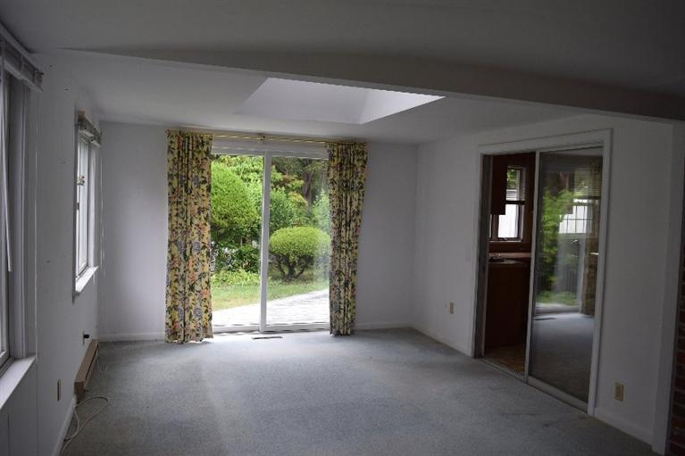 62 Cedar Land Road Orleans, MA 02653 - Photo 10 of 30 an empty room with floor to ceiling windows and garden