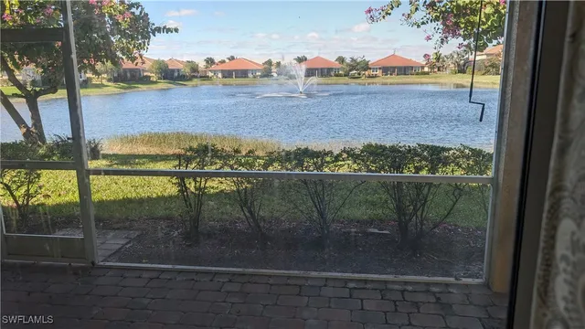 a kitchen with granite countertop a sink dishwasher stove and cabinets