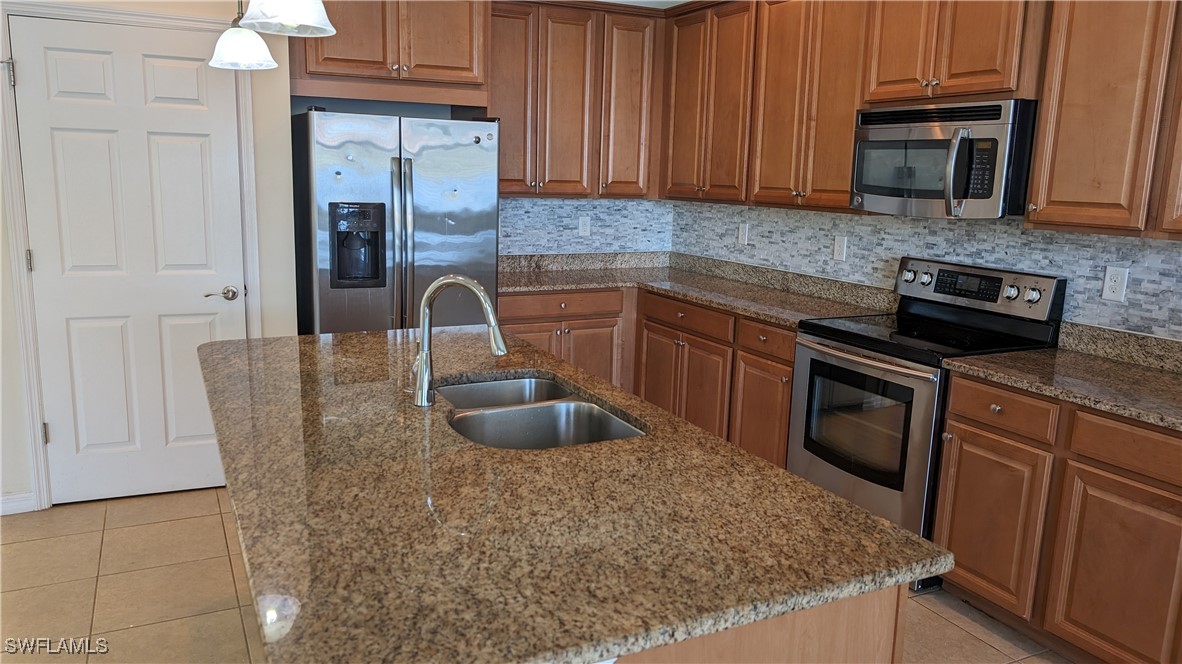3552 Brittons Court Fort Myers, FL 33916 - Photo 13 of 27 a kitchen with granite countertop a sink dishwasher stove and cabinets