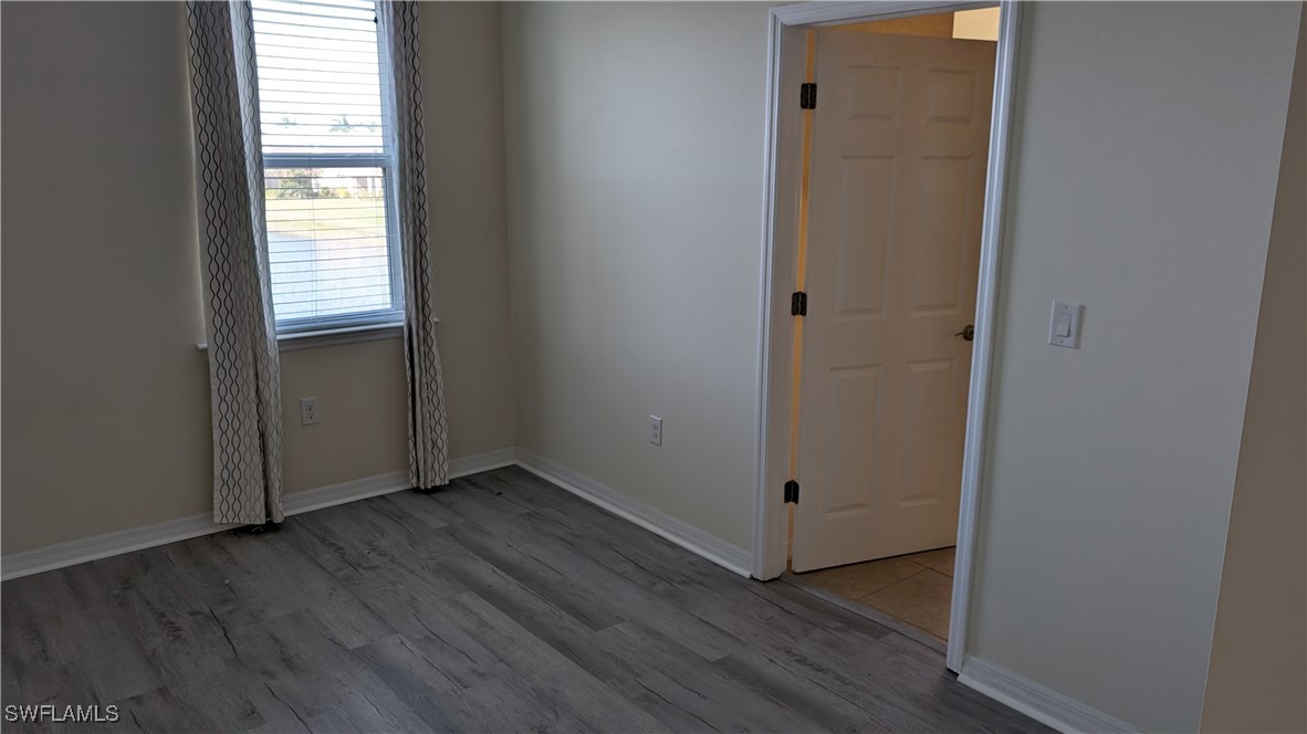 3552 Brittons Court Fort Myers, FL 33916 - Photo 20 of 27 a view of an empty room with wooden floor and a window