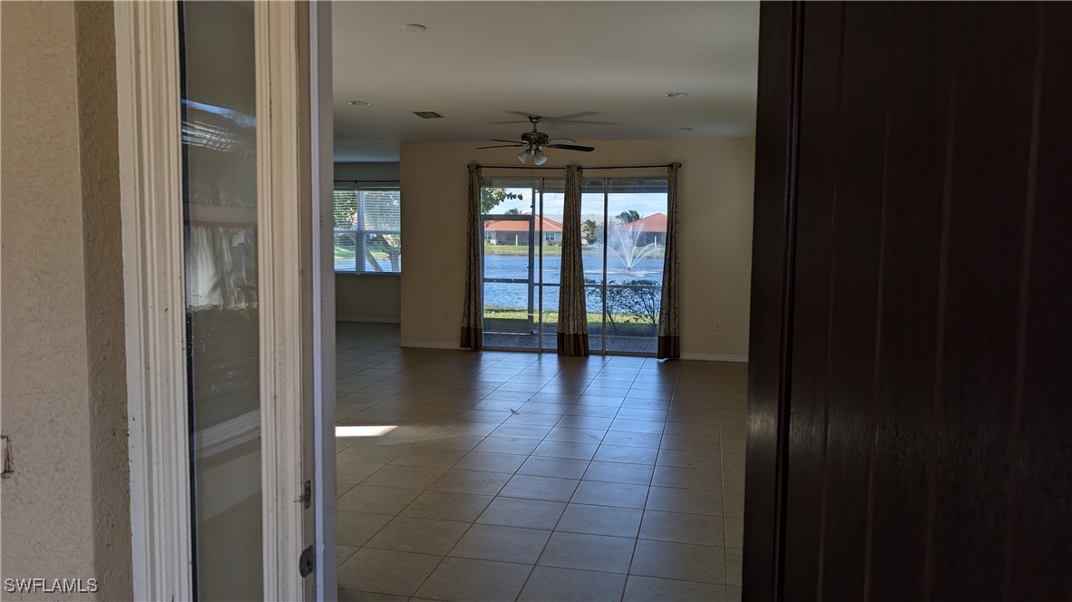 3552 Brittons Court Fort Myers, FL 33916 - Photo 3 of 27 a view of a hallway with wooden floor and a bathroom