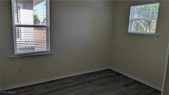 an empty room with wooden floor