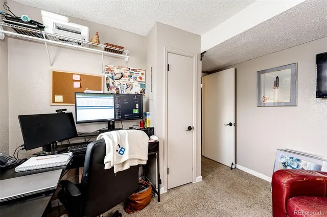 a bedroom with bed and a desk