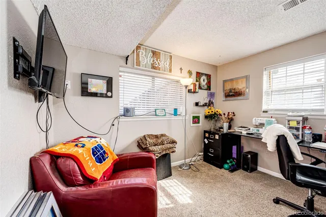 a bedroom with a workspace