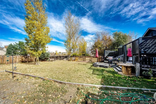 a view of a porch with furniture and a yard
