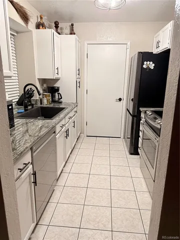 a kitchen with stainless steel appliances a sink and a refrigerator