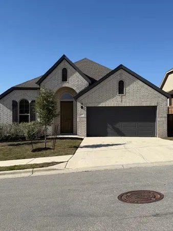 a front view of a house with garage