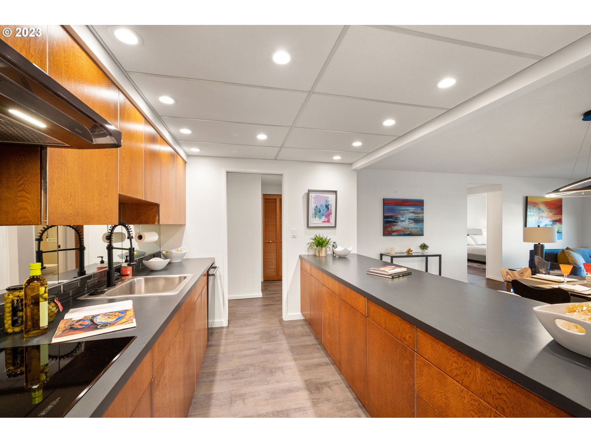 2309 Southwest 1st Avenue, Unit 441 Portland, OR 97201 - Photo 21 of 39 a large kitchen with kitchen island granite countertop a large counter top appliances and cabinets
