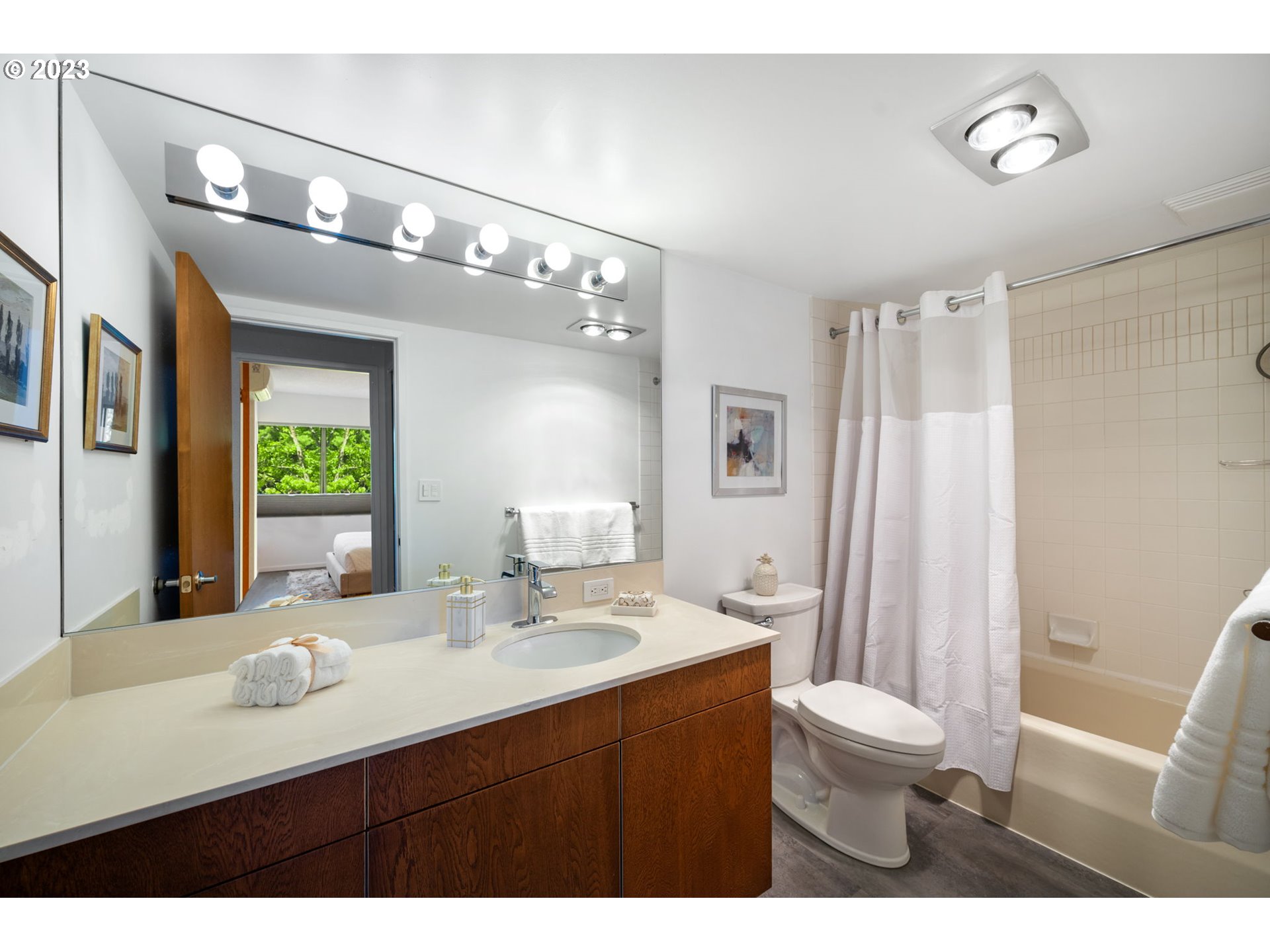 2309 Southwest 1st Avenue, Unit 441 Portland, OR 97201 - Photo 24 of 39 a bathroom with a sink a toilet a mirror a vanity and shower