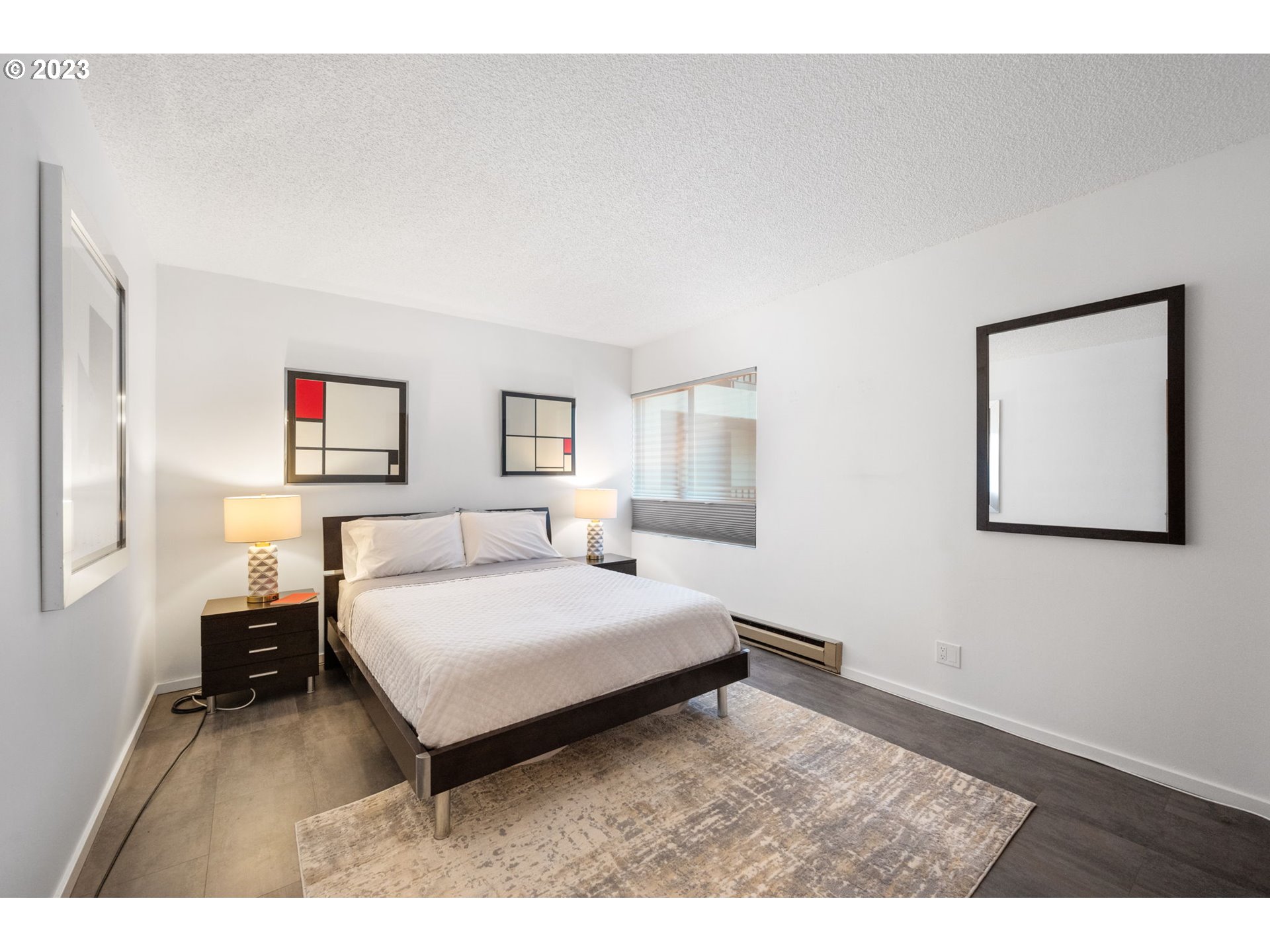 2309 Southwest 1st Avenue, Unit 441 Portland, OR 97201 - Photo 25 of 39 a living room with a bed furniture and a window