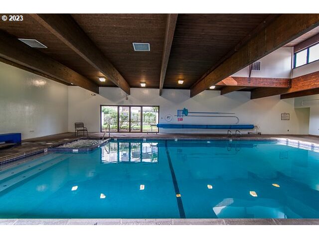 2309 Southwest 1st Avenue, Unit 441 Portland, OR 97201 - Photo 35 of 39 a open kitchen with kitchen island a sink dishwasher and a stove with wooden floor