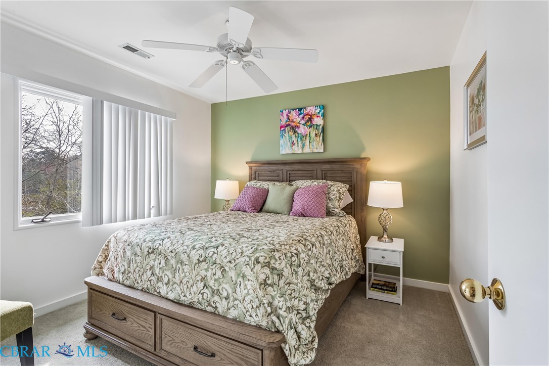 172 Sturgeon Creek Road Deltaville, VA 23043 - Photo 23 of 50 Carpeted guest bedroom with baseboards and ceiling fan