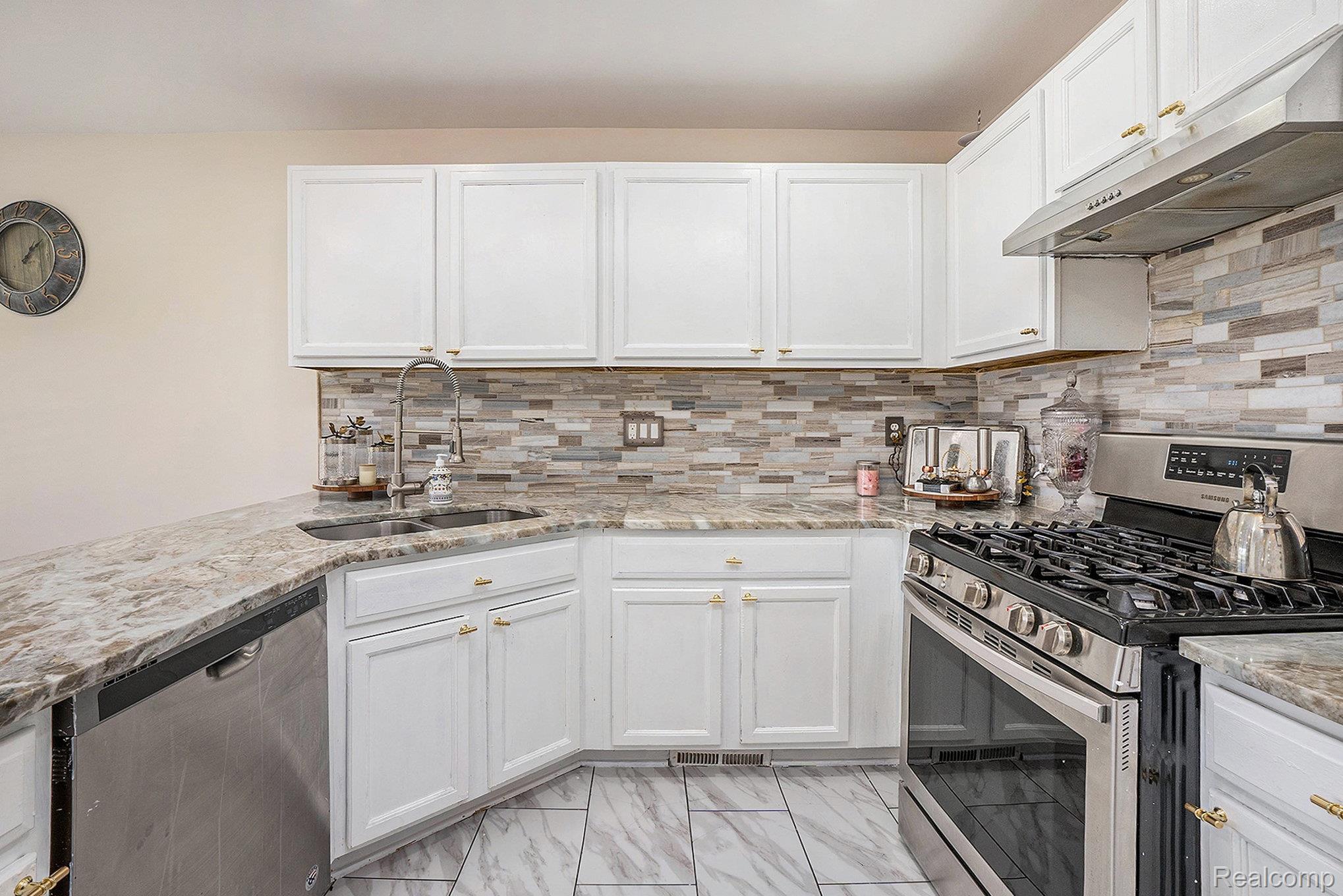 5477 Victory Circle Sterling Heights, MI 48310 - Photo 14 of 32 Kitchen featuring white cabinetry, a stainless steel gas range, a coordinating dishwasher, and a double basin sink with a gooseneck faucet