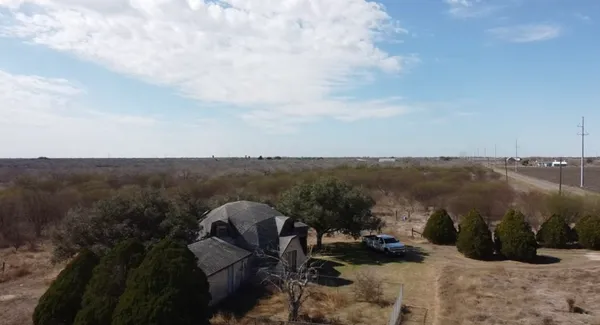 a view of a wooden house with a yard