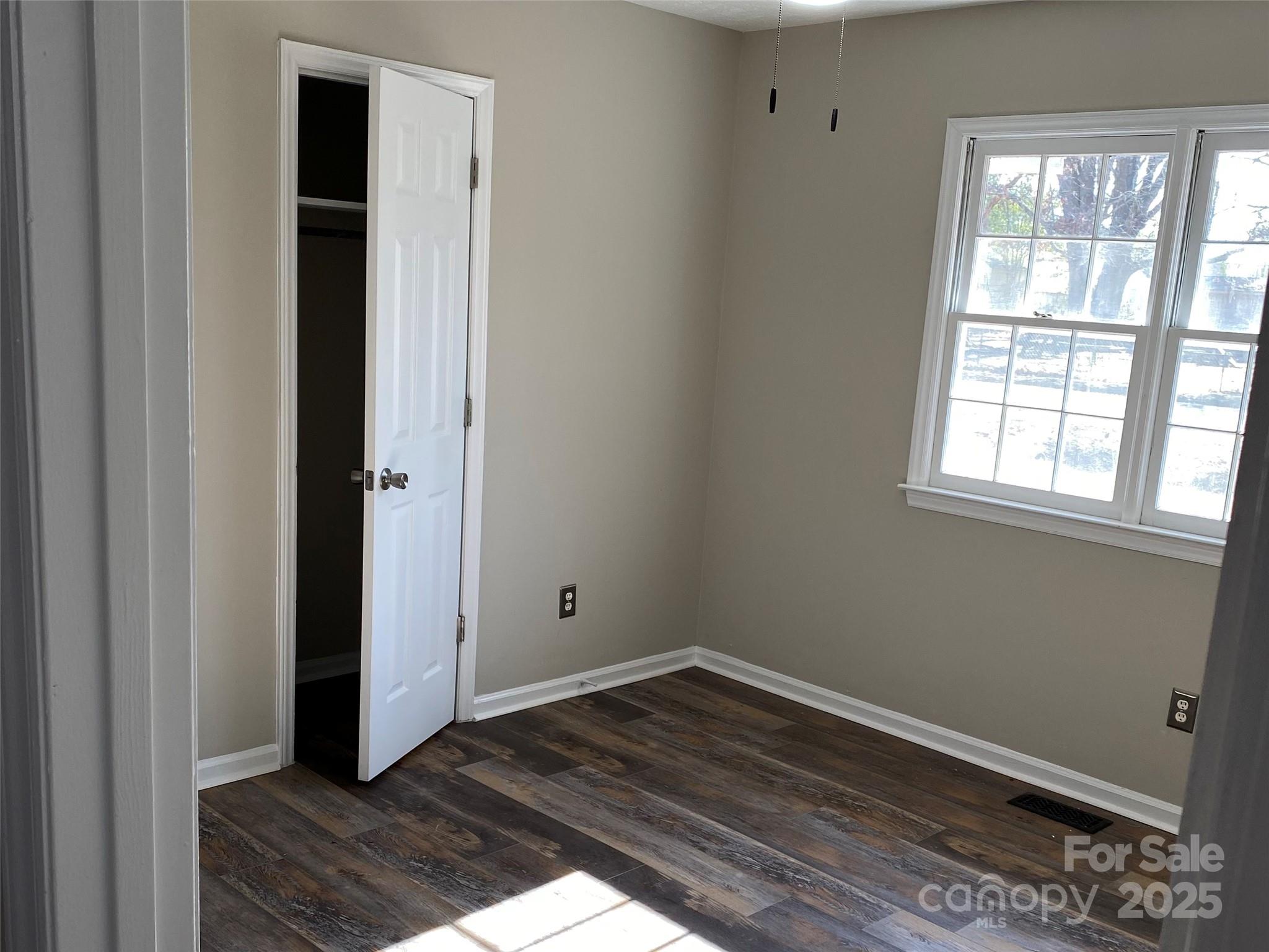 802 Marshall Street Cheraw, SC 29520 - Photo 11 of 16 an empty room with wooden floor and closet