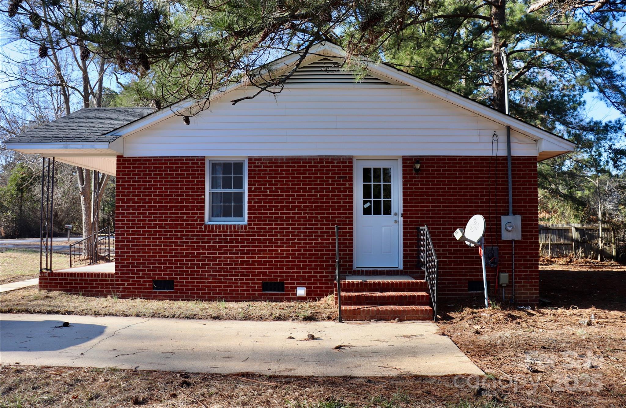 802 Marshall Street Cheraw, SC 29520 - Photo 15 of 16 a backyard of a house with wooden floor and outdoor seating