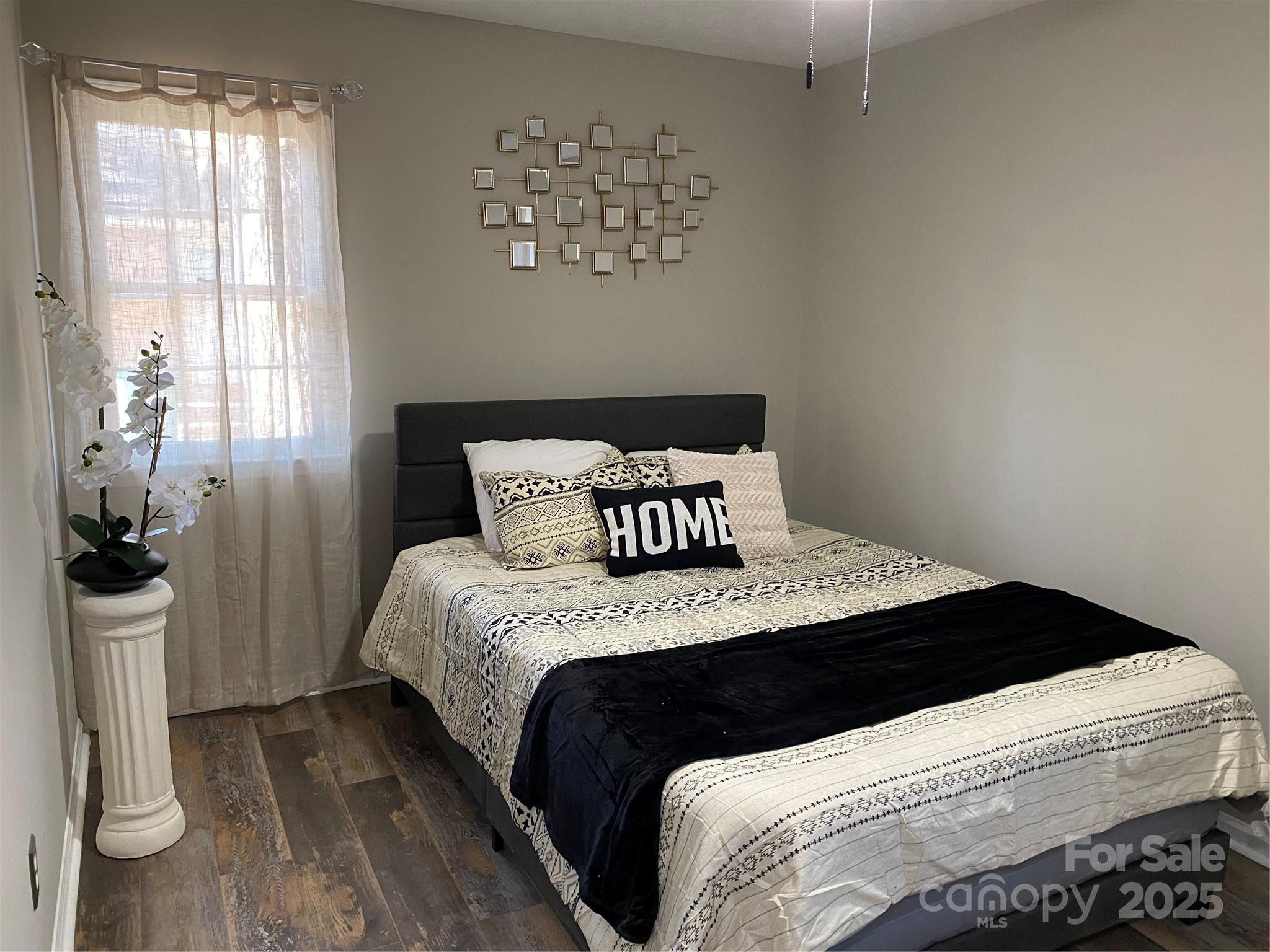 802 Marshall Street Cheraw, SC 29520 - Photo 8 of 16 a bedroom with a bed and wooden floor