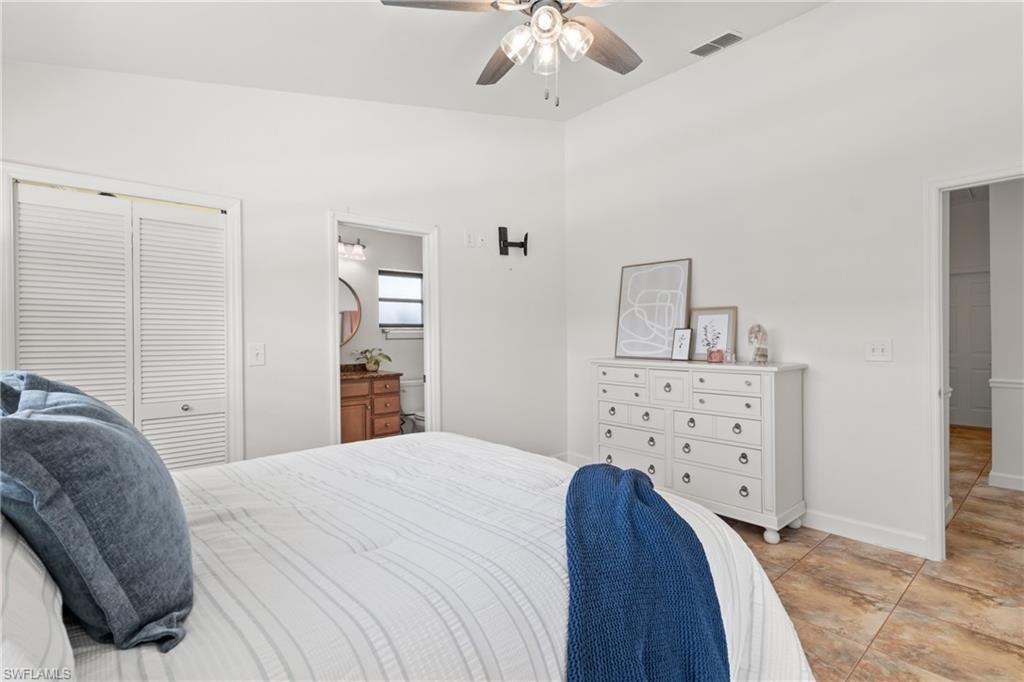 1348 Monarch Circle Naples, FL 34116 - Photo 15 of 33 a bedroom with a bed and a chandelier