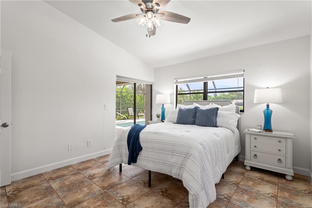 1348 Monarch Circle Naples, FL 34116 - Photo 16 of 33 a bedroom with a bed and a chandelier