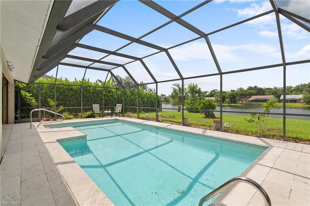 1348 Monarch Circle Naples, FL 34116 - Photo 2 of 33 a view of a swimming pool with a porch