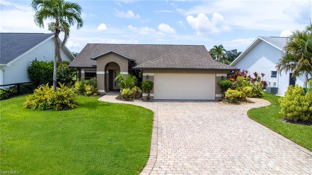 1348 Monarch Circle Naples, FL 34116 - Photo 24 of 33 a front view of a house with garden