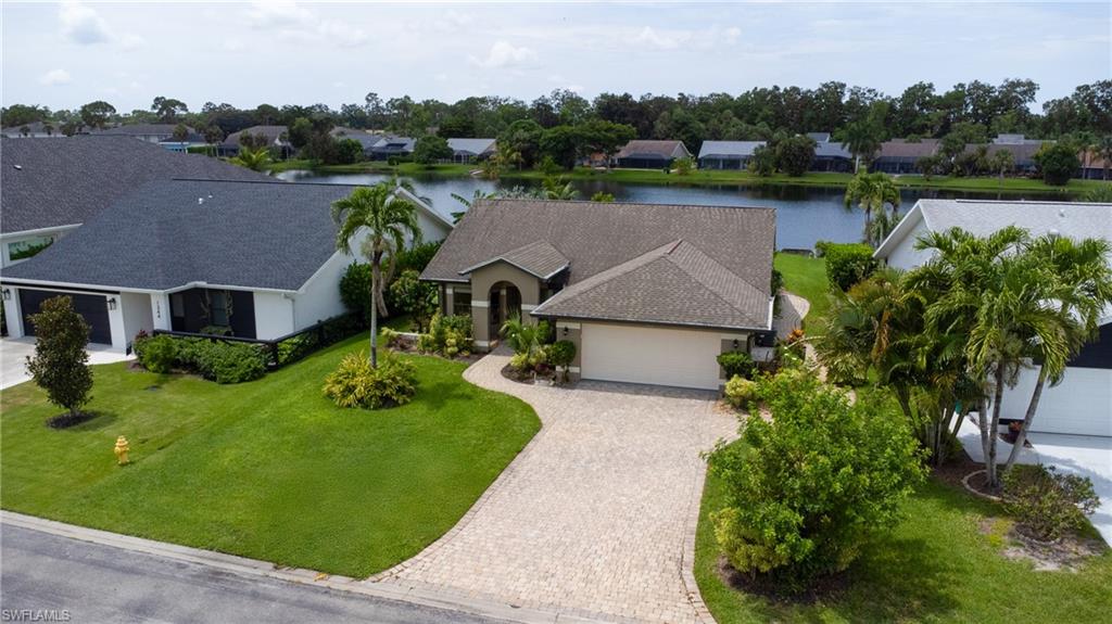 1348 Monarch Circle Naples, FL 34116 - Photo 30 of 33 an aerial view of a house with a garden and lake view