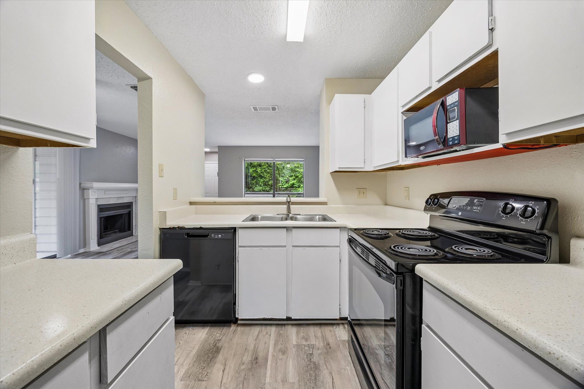 2018 West Rundberg Lane, Unit 13A Austin, TX 78758 - Photo 5 of 11 a kitchen with stainless steel appliances granite countertop a stove and a sink