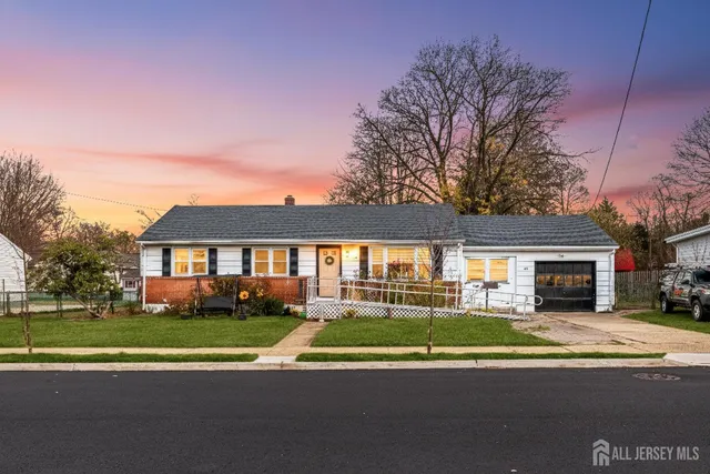 a view of house with a big yard and potted plants