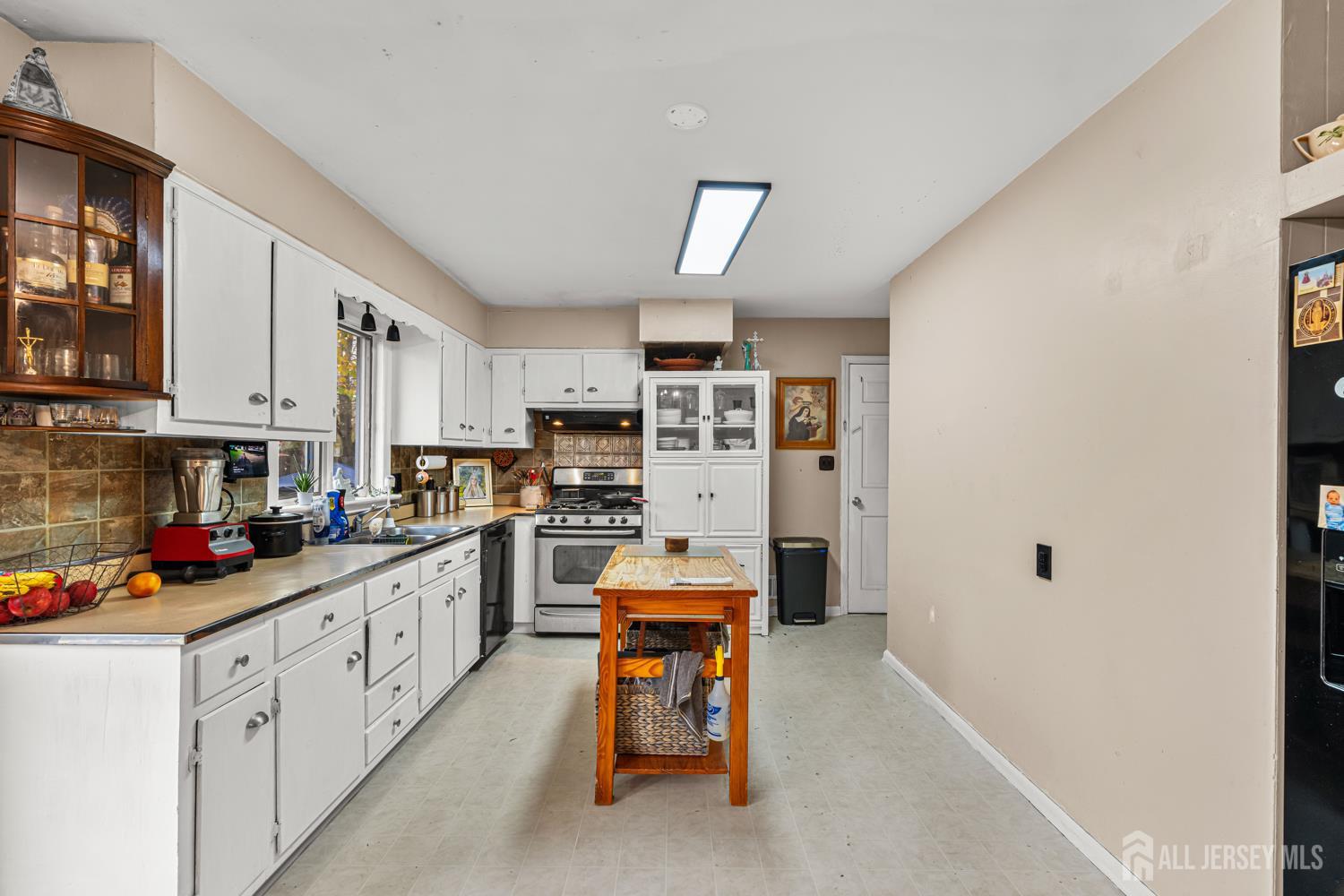 149 Springdale Avenue Hamilton, NJ 08620 - Photo 18 of 43 a kitchen with stainless steel appliances a stove refrigerator a sink dishwasher and cabinets with wooden floor