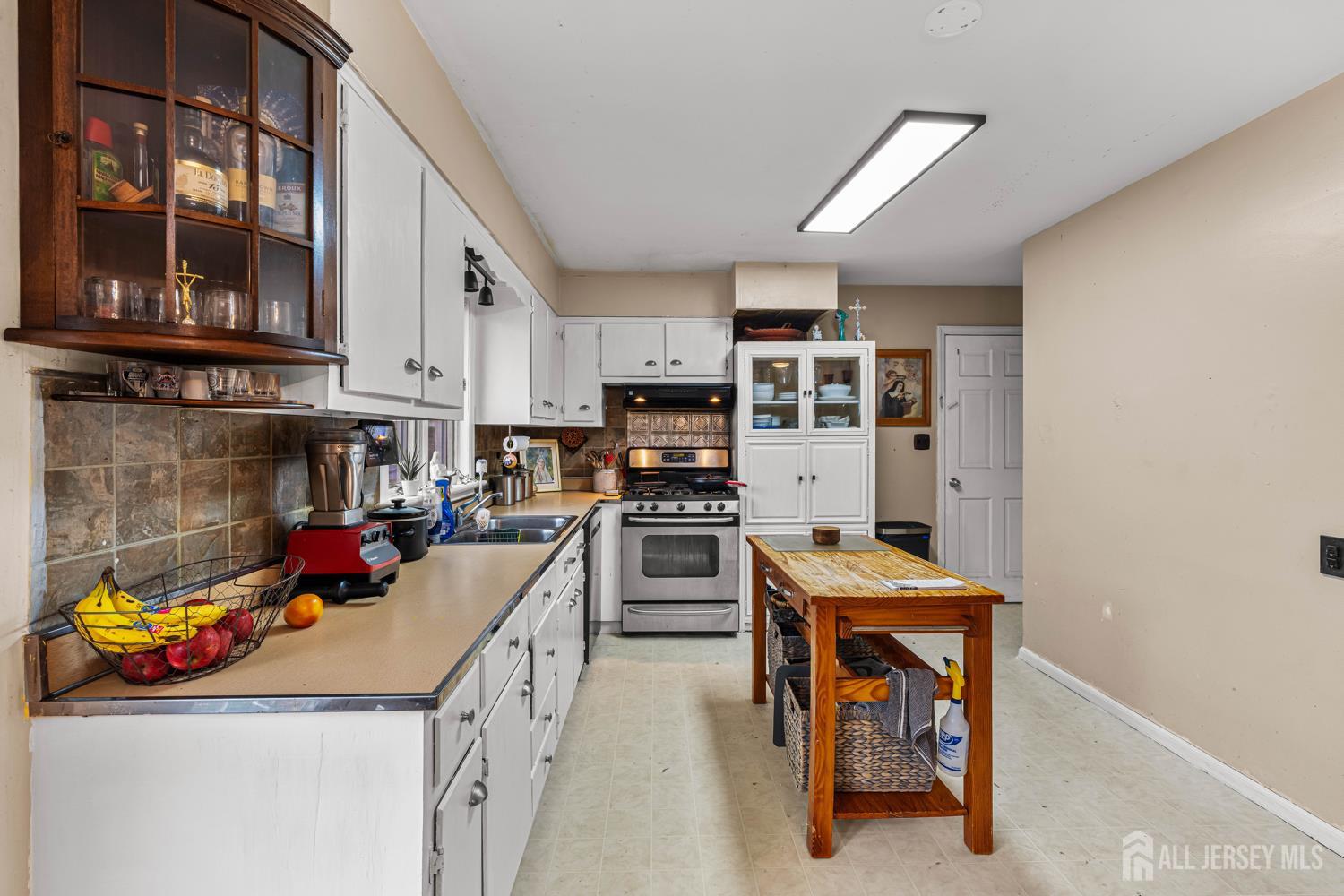 149 Springdale Avenue Hamilton, NJ 08620 - Photo 20 of 43 a kitchen with stainless steel appliances granite countertop a stove and cabinets