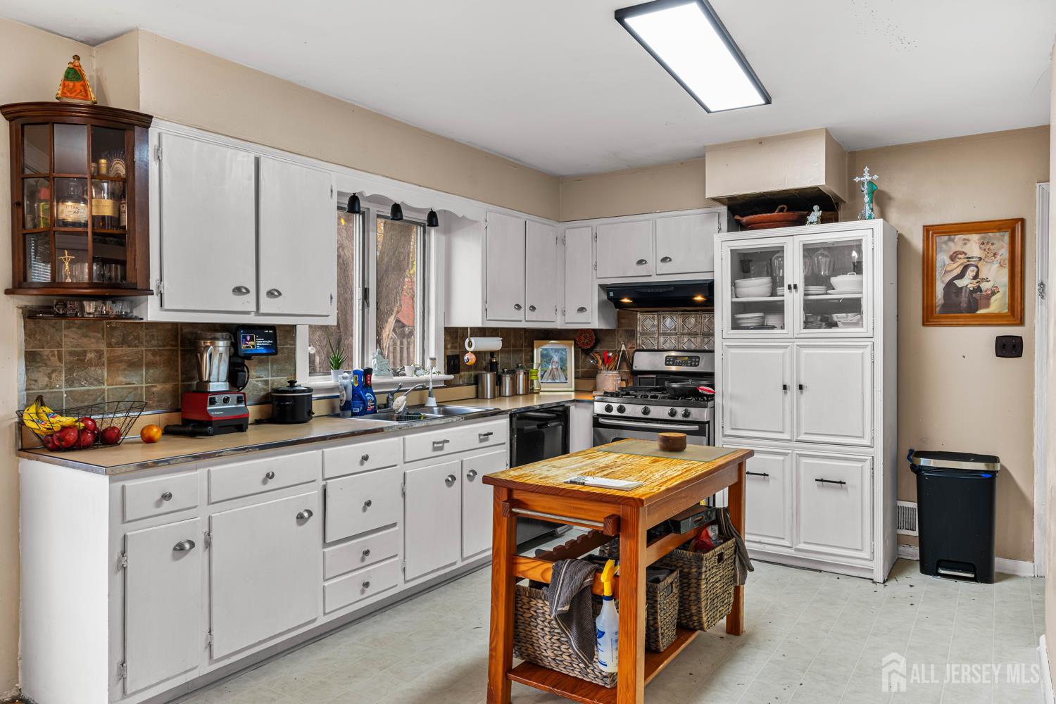 149 Springdale Avenue Hamilton, NJ 08620 - Photo 22 of 43 a kitchen with stainless steel appliances granite countertop a stove top oven a sink dishwasher and a refrigerator with wooden cabinets