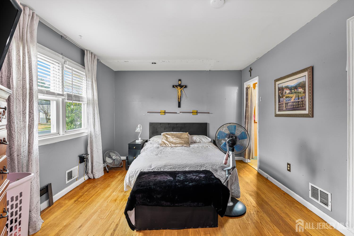 149 Springdale Avenue Hamilton, NJ 08620 - Photo 27 of 43 a bed sitting in a bedroom next to a window