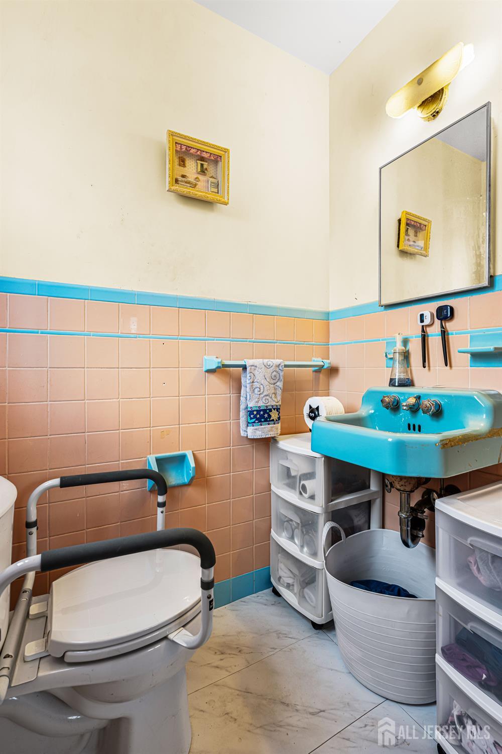 149 Springdale Avenue Hamilton, NJ 08620 - Photo 32 of 43 a bathroom with a toilet a sink and a mirror