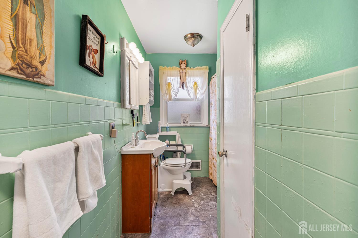 149 Springdale Avenue Hamilton, NJ 08620 - Photo 34 of 43 a bathroom with a toilet sink and mirror