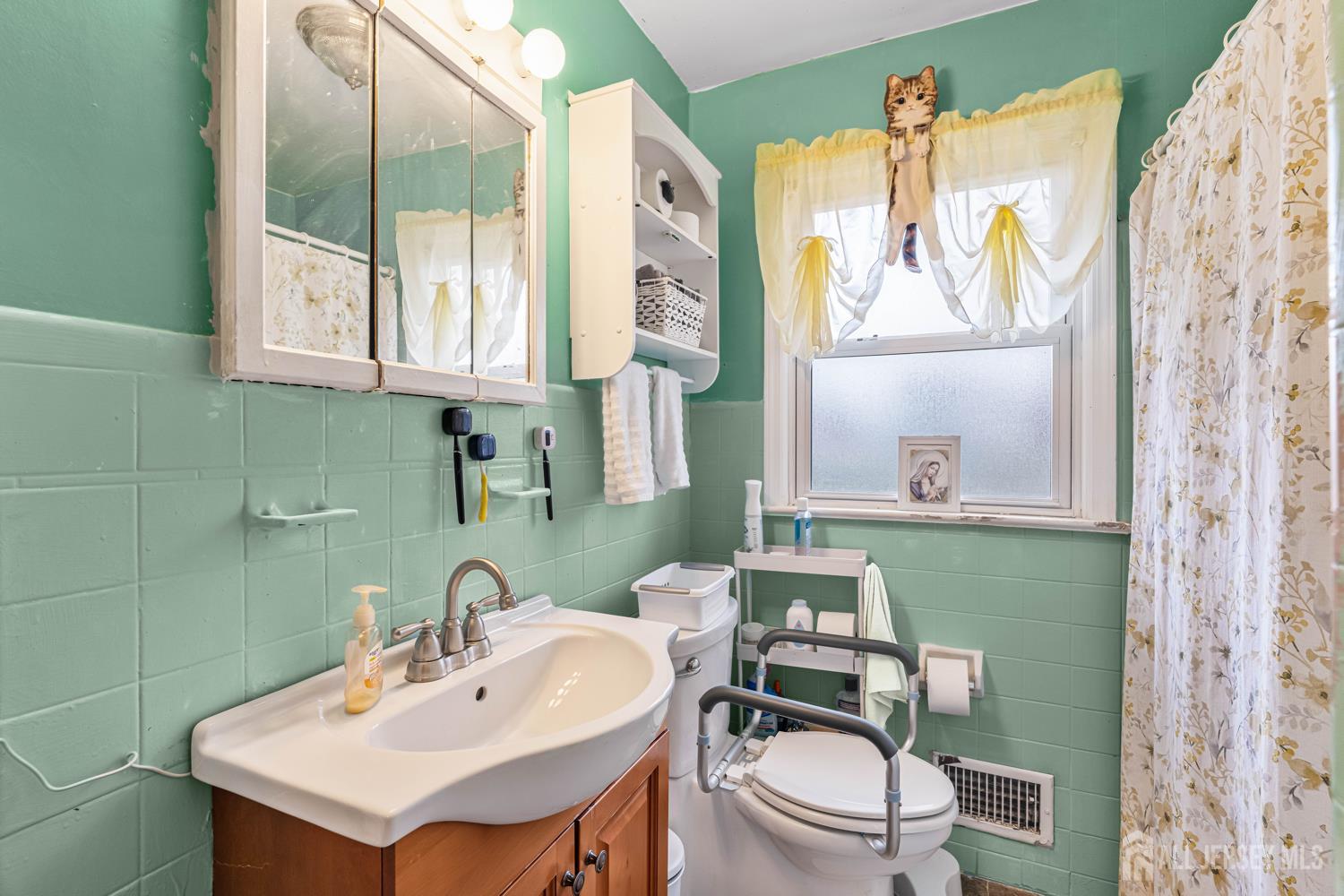 149 Springdale Avenue Hamilton, NJ 08620 - Photo 35 of 43 a bathroom with a sink a toilet and a mirror