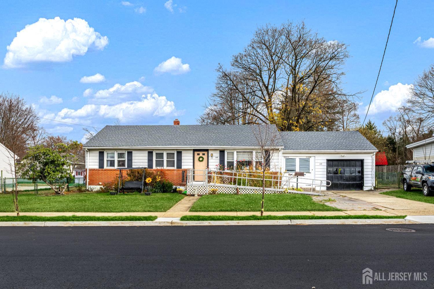 149 Springdale Avenue Hamilton, NJ 08620 - Photo 5 of 43 a front view of a house with a yard and potted plants