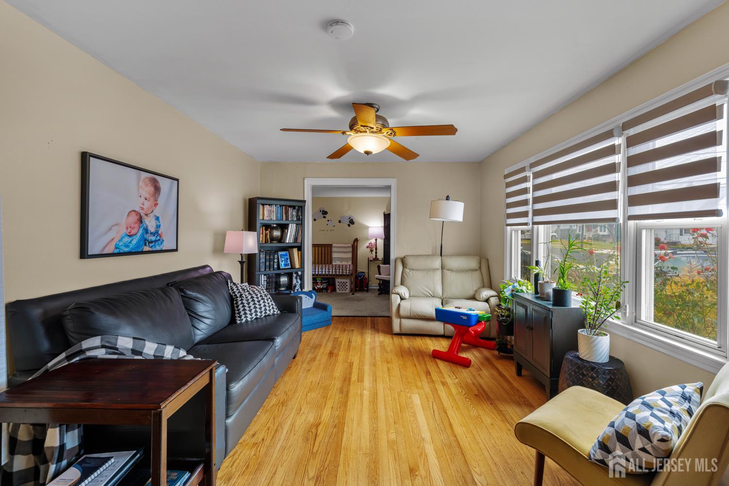 149 Springdale Avenue Hamilton, NJ 08620 - Photo 7 of 43 a living room with furniture two window and a flat screen tv