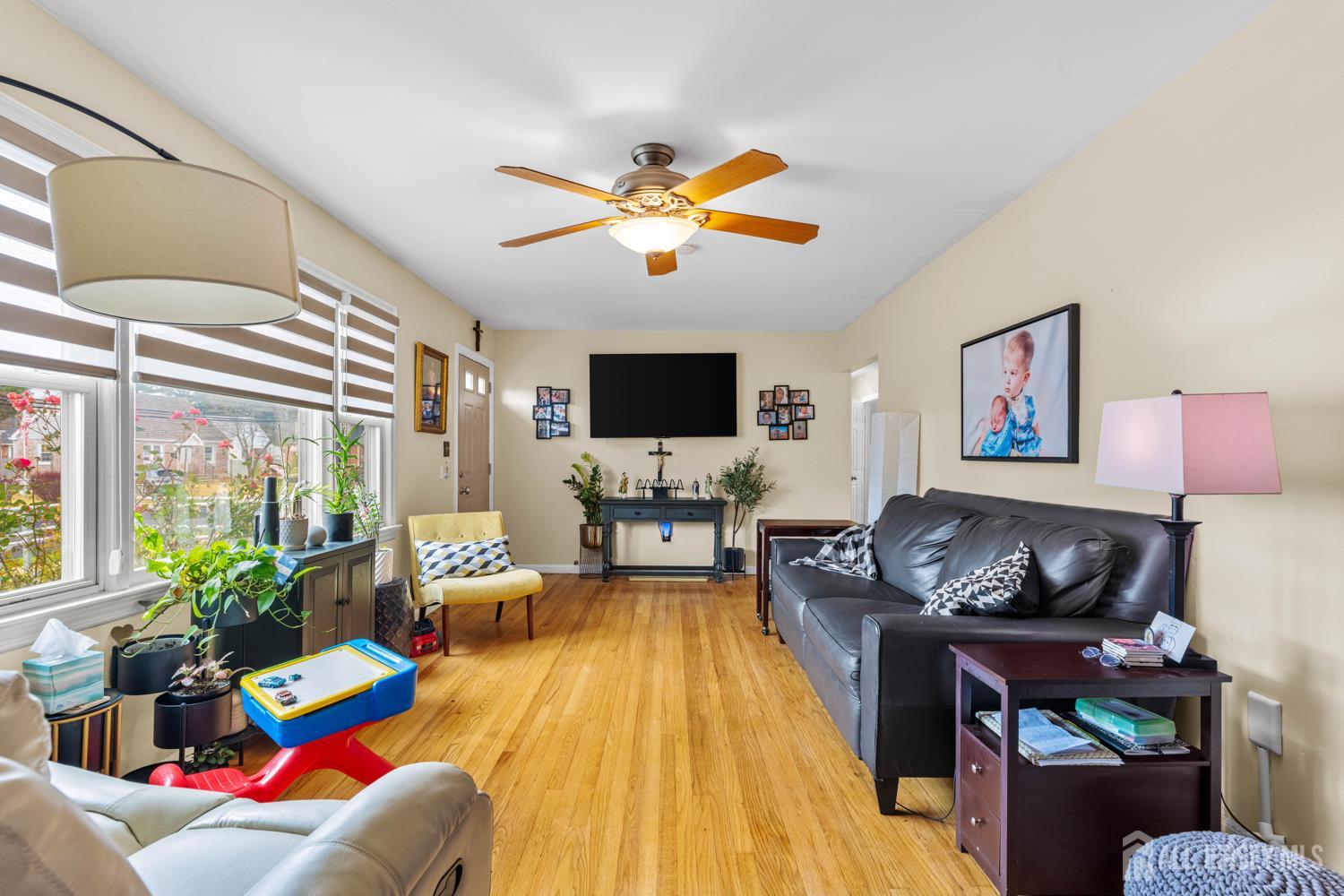 149 Springdale Avenue Hamilton, NJ 08620 - Photo 8 of 43 a living room with furniture and a flat screen tv