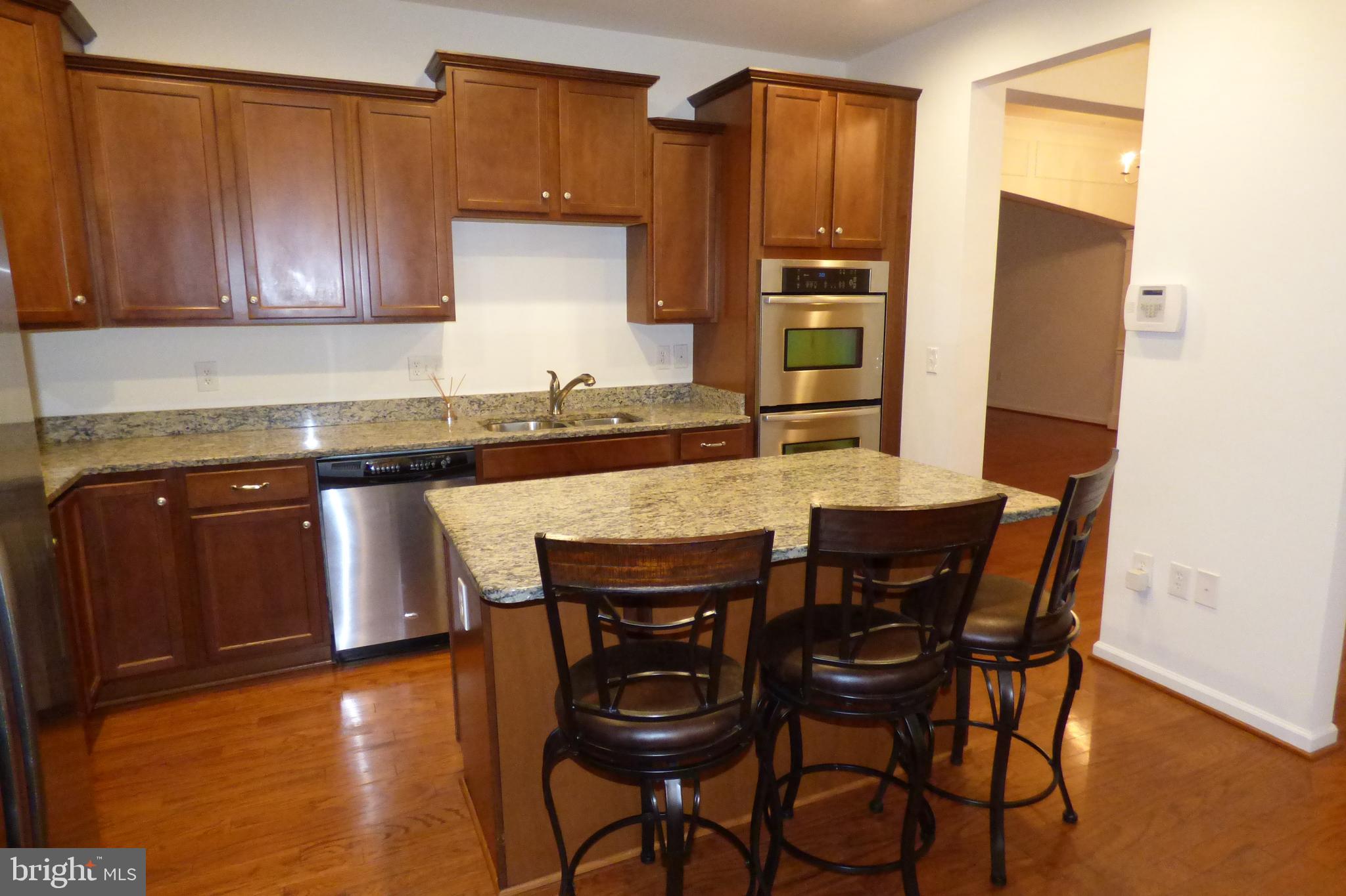 13113 Winding Trail Road Laurel, MD 20707 - Photo 17 of 47 a kitchen with granite countertop wooden cabinets and stainless steel appliances