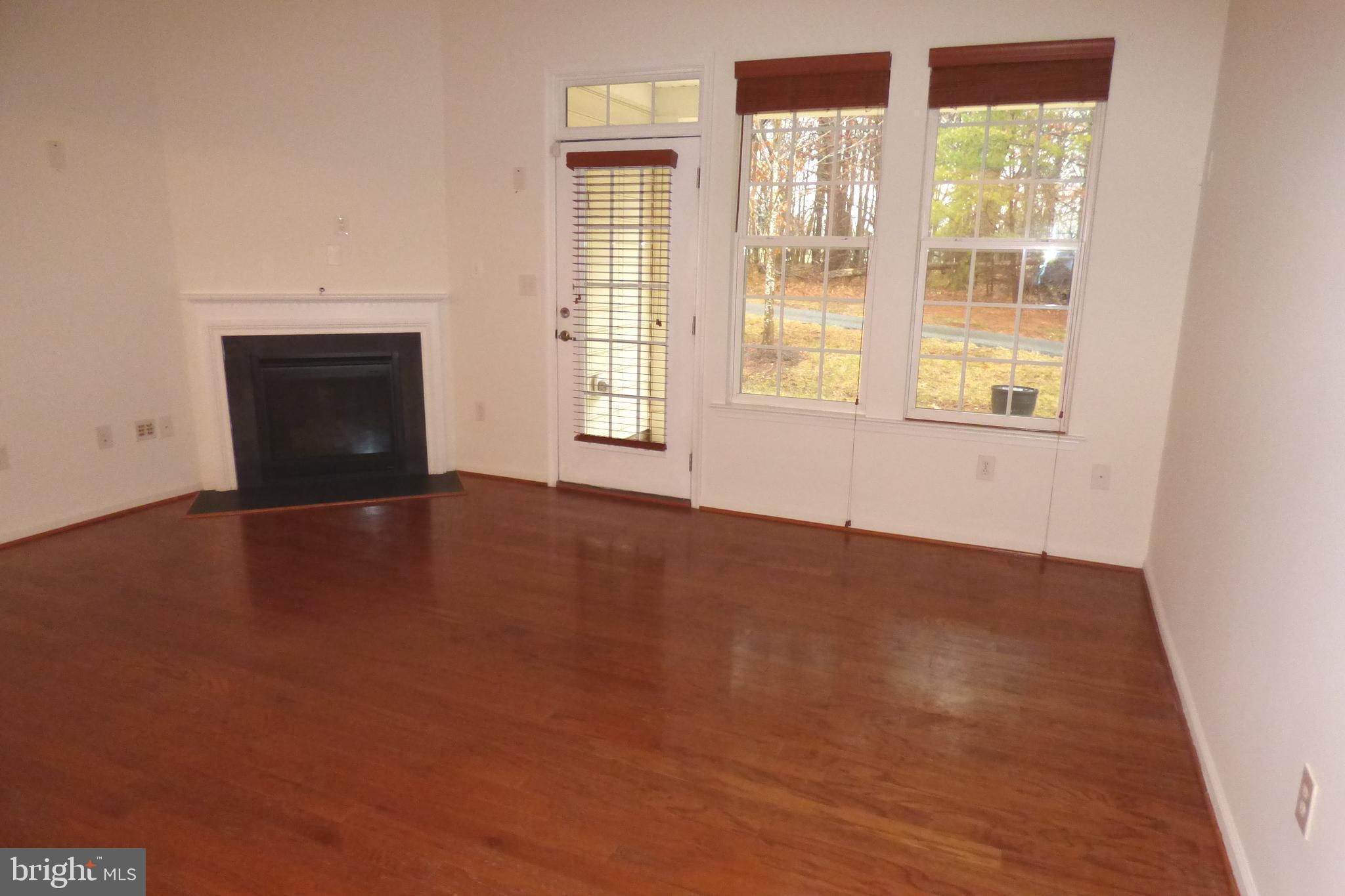 13113 Winding Trail Road Laurel, MD 20707 - Photo 21 of 47 a view of an empty room with a window and wooden floor